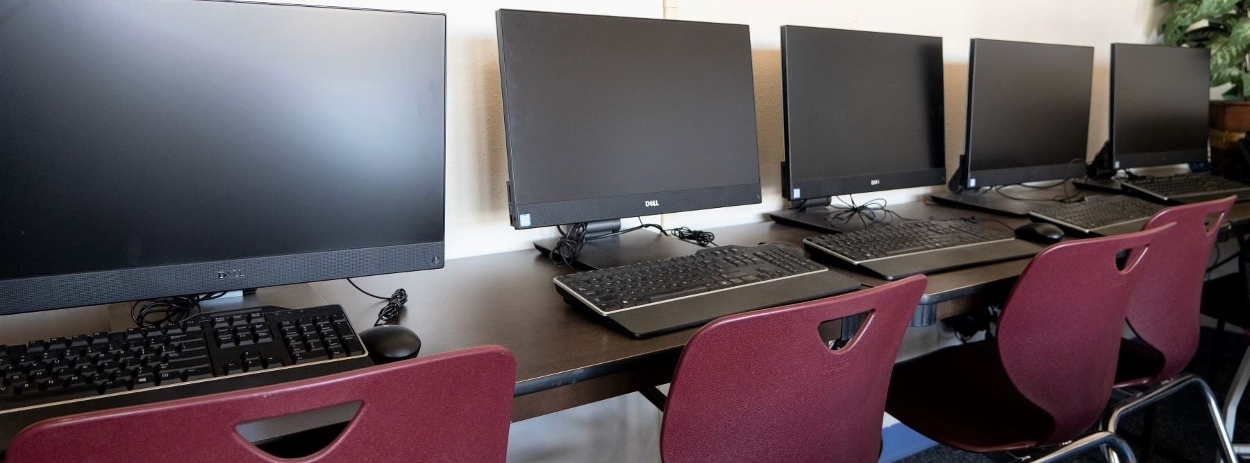 table with computers lined up side by side