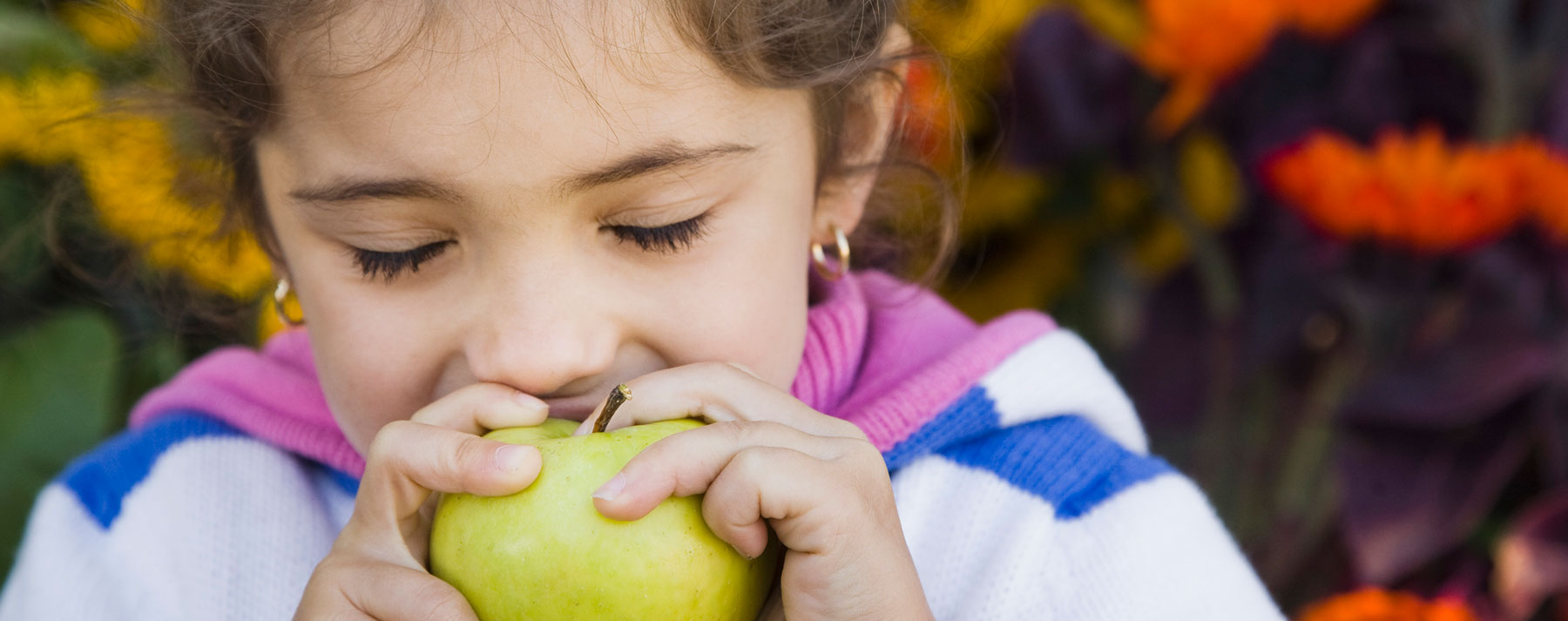 Young girl eating an apple